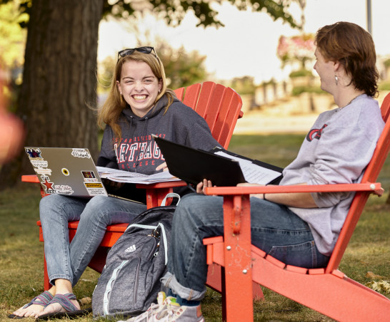 Take a seat! Red adirondack chairs are found all over campus.