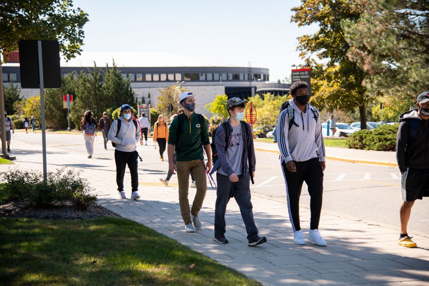 Students walk down Campus Drive on the way to class.
