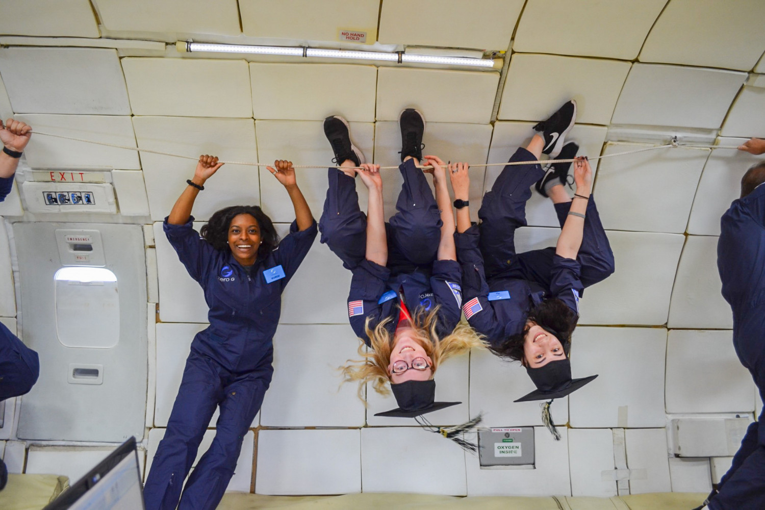 Students on board NASA's zero gravity aircraft take a break from conducting research to celebrate...