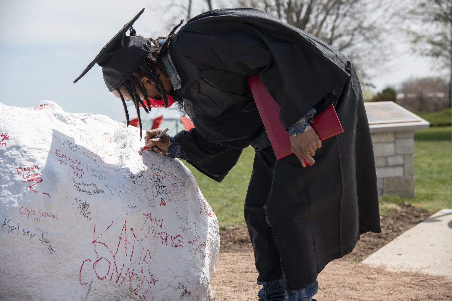 Today, students sign their names on Kissing Rock when they first arrive on campus, and four years...