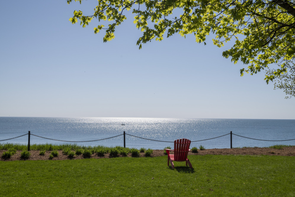 A red chair looks out to Lake Michigan.