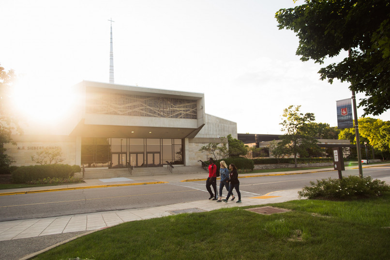 Students walking in front of chapel.