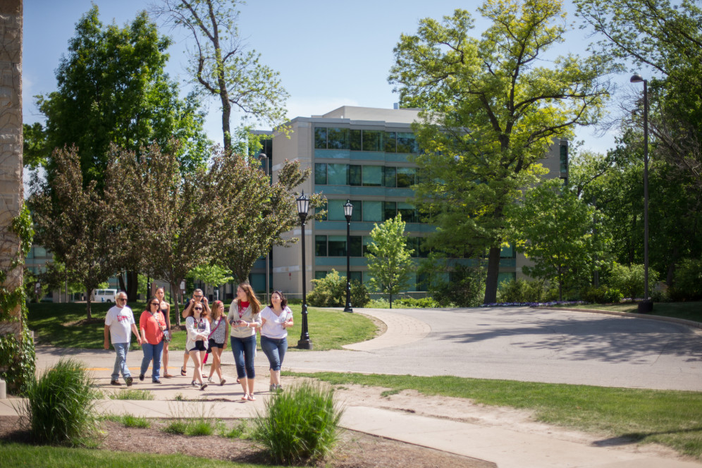 A student ambassador gives a campus tour to prospective students.