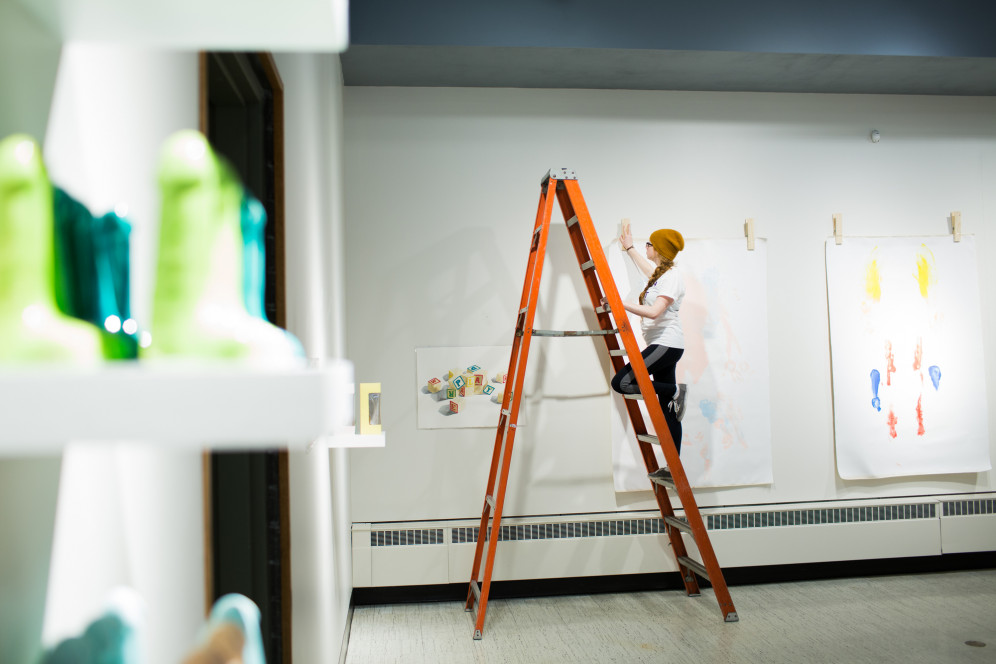 A gallery assistant builds an exhibition in the H. F. Gallery of Art.