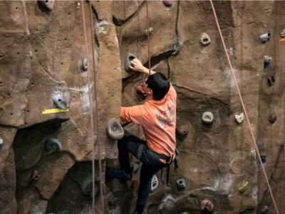 Student scaling the Rock Climbing Wall.