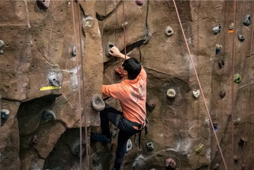 Student scaling the Rock Climbing Wall.