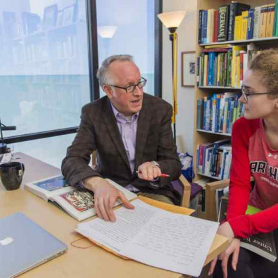Prof. Greg Baer works with a student in his office.