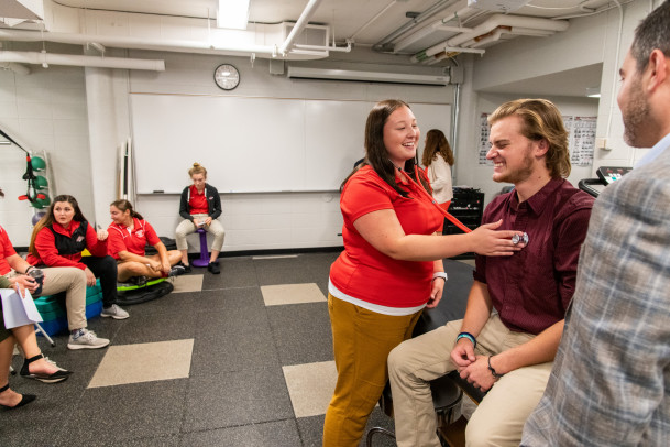 Students practice assessing one another in an athletic training class.