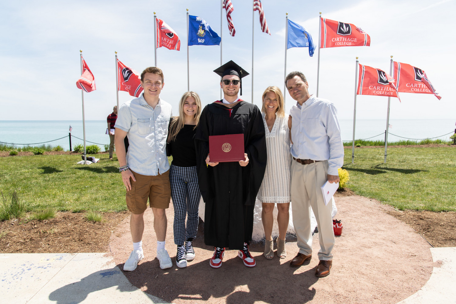 At the end of the Commencement Procession, Carthage graduates signed Kissing Rock and posed for p...