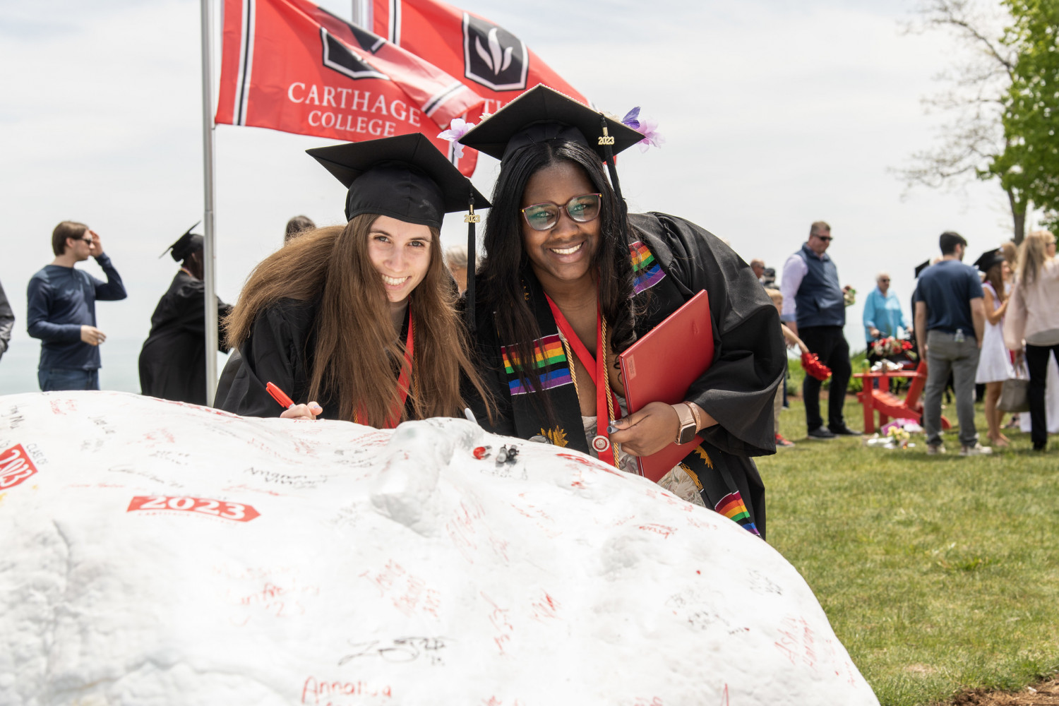 At the end of the Commencement Procession, Carthage graduates signed Kissing Rock and posed for p...