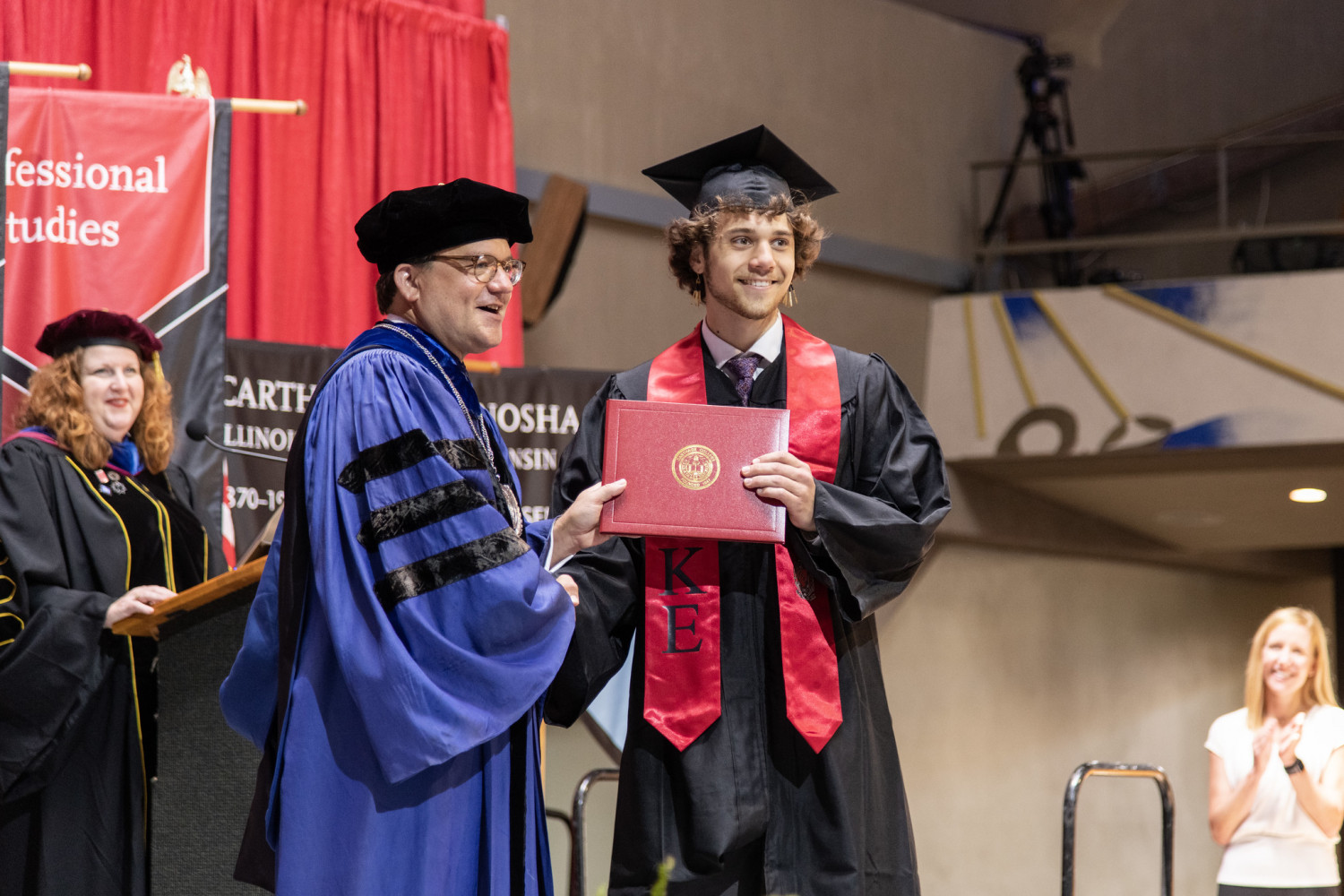 Carthage graduates processed through several campus buildings with family and friends culminating...