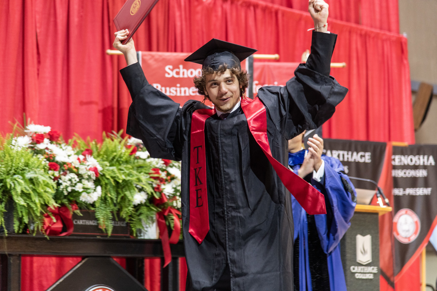 Carthage graduates processed through several campus buildings with family and friends culminating...