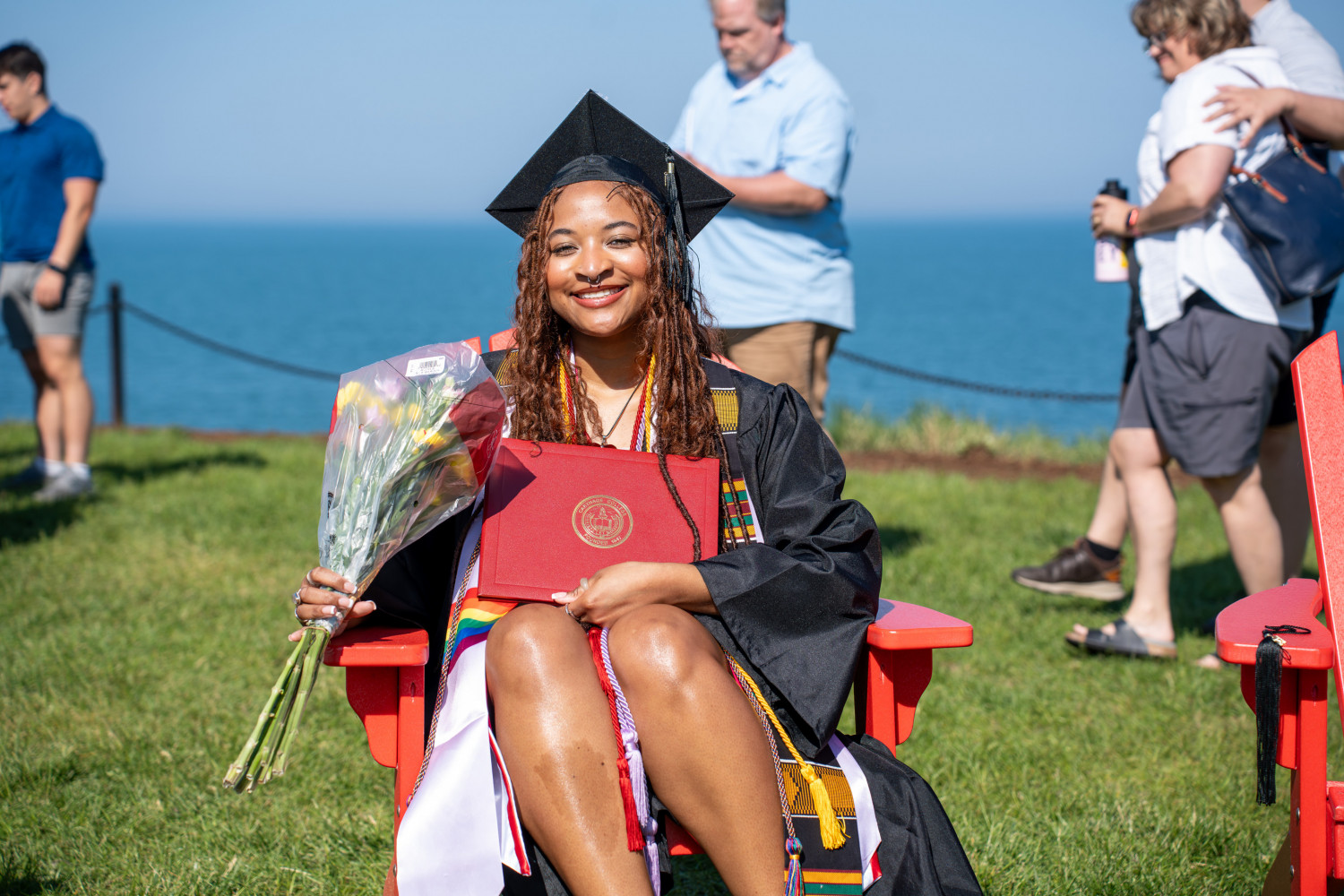 Students sat in the iconic red Adirondack chairs with their diplomas.
