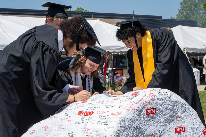 Students signed the Kissing Rock with their fellow graduates.