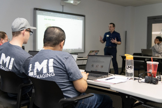 Carthage professor Joseph Tenuta teaches an Intro to Business Class at LMI Packaging as part of t...