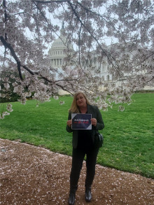Prof. Nancy Reese by the cherry blossoms on Capitol Hill.