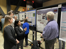 Hannah Poff ?24 and Kate Talens ?24 explaining their research to Carthage collaborator Professor ...