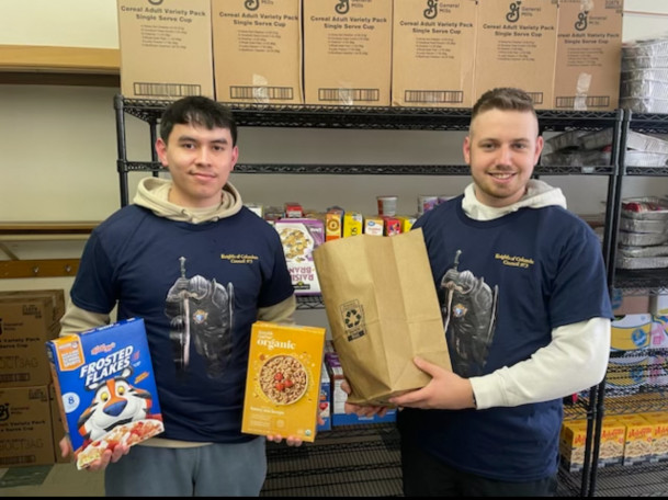 Kevin Lagunas ?24 (left) and Thomas Connolly ?27 (right) worked at the St. Anthony's food pantry ...