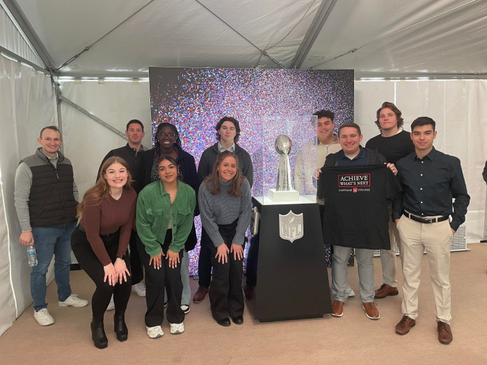 Students in The Front office with the NFL Super Bowl trophy.