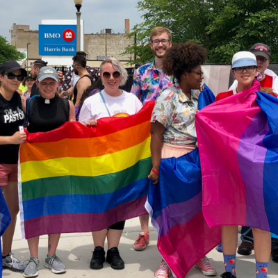Carthage community members with LGBTQ+ pride flags.