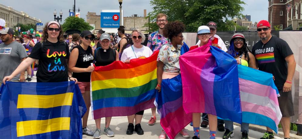 Carthage community members with LGBTQ+ pride flags.