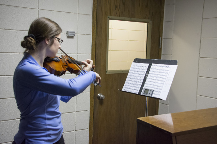 A student practicing in one of the Practice Rooms in the H. F. Johnson Center for the Arts.
