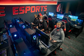 Students playing video games in the esports gaming studio.