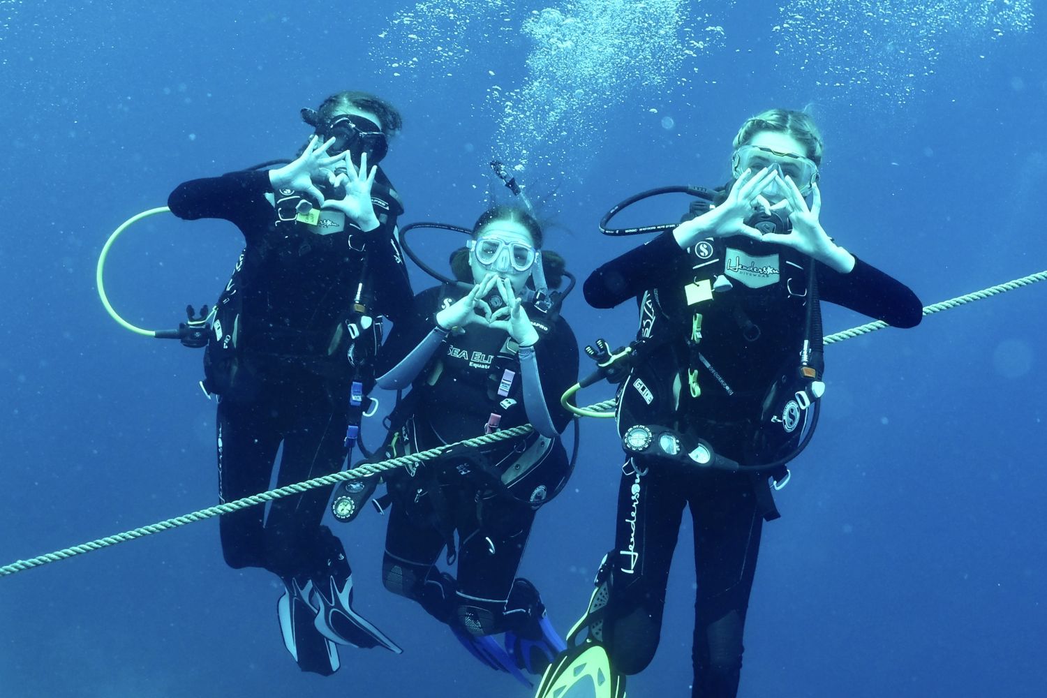 Students pose to take a photo while scuba diving in Honduras for J-Term.
