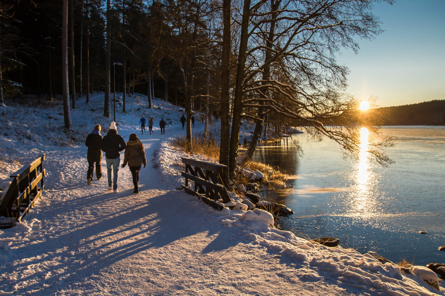 People strolling past Sognsvann Lake in Oslo, Norway.