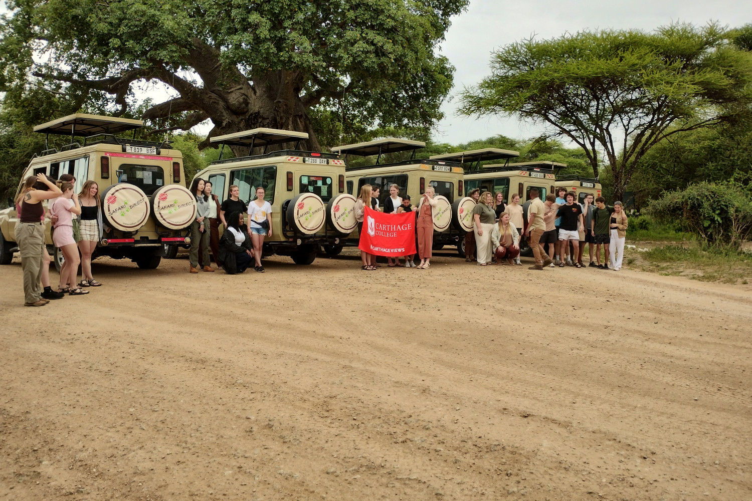 Students boarding safari vehicles.
