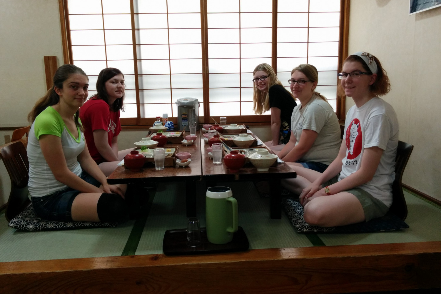 Students sitting for a traditional meal.