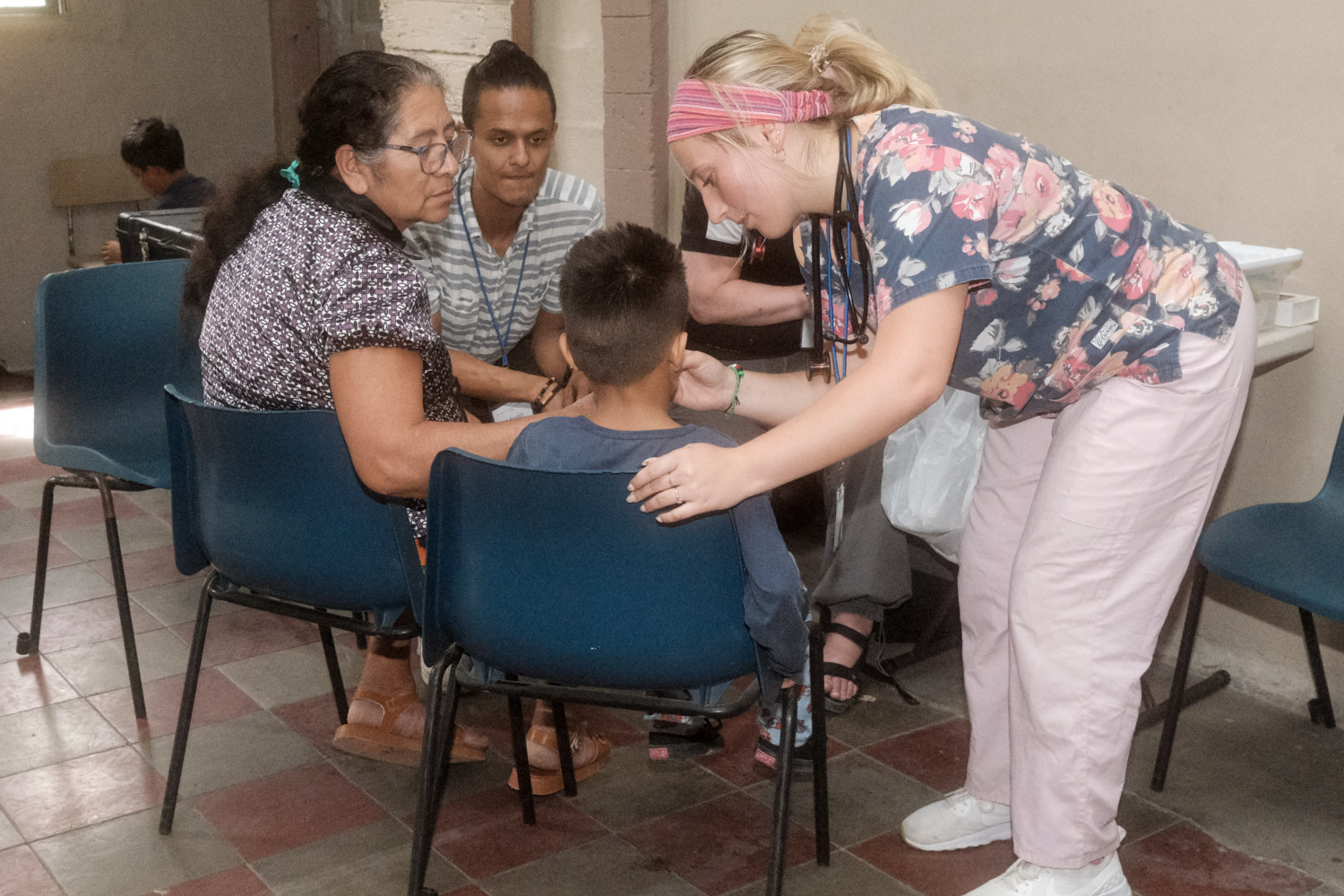 A student providing medical service to a child.