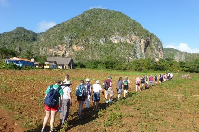 Students hiking towards a mountain range in Cuba