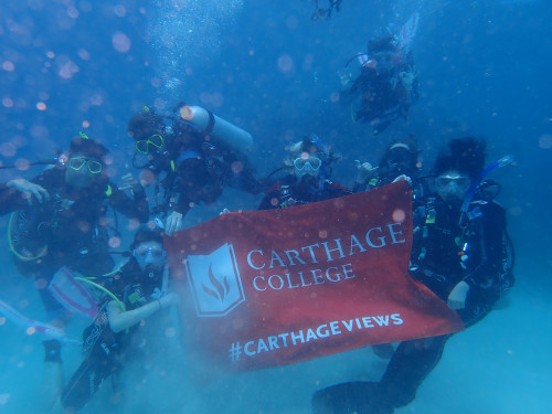 My dive group and I taking an underwater photo with the Carthage flag.