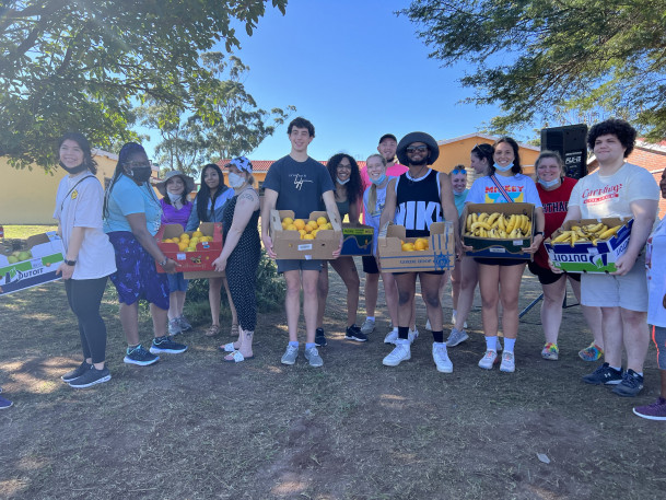 Students passing out fruit.