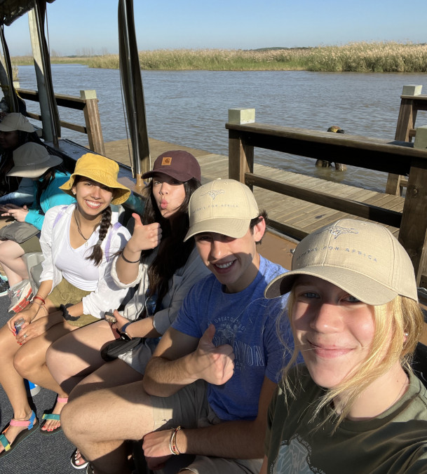 Students taking a boat to see exotic wildlife.