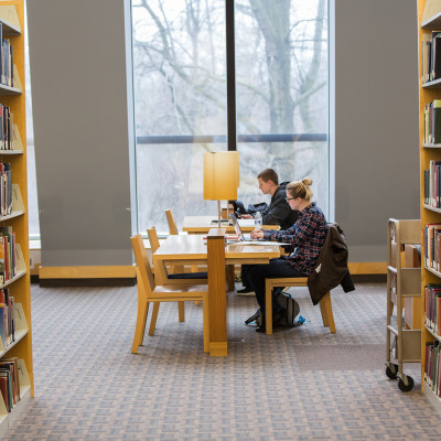 Students studying at a table in Hedberg Library.