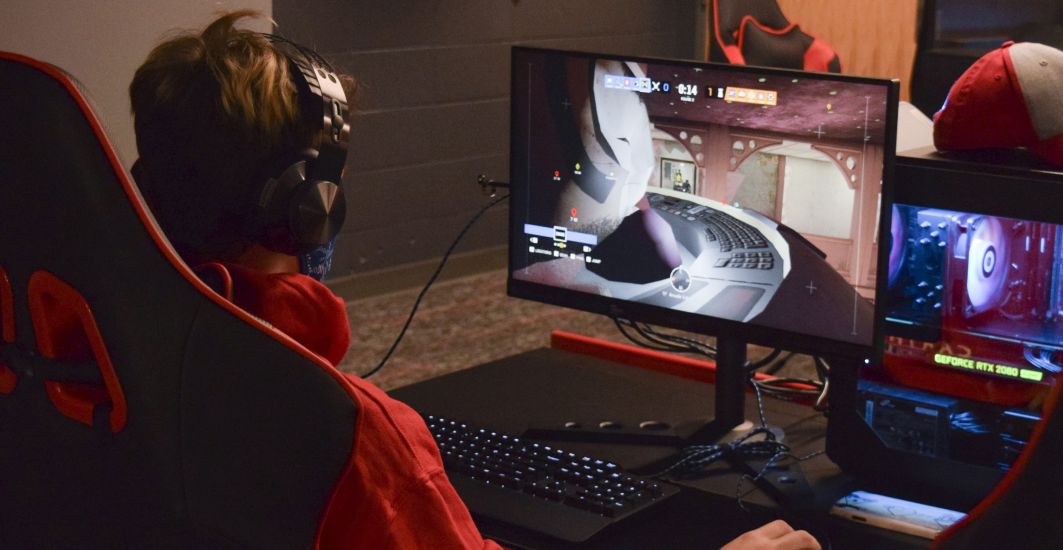 A student plays a video game in the new Esports Arena at Carthage.
