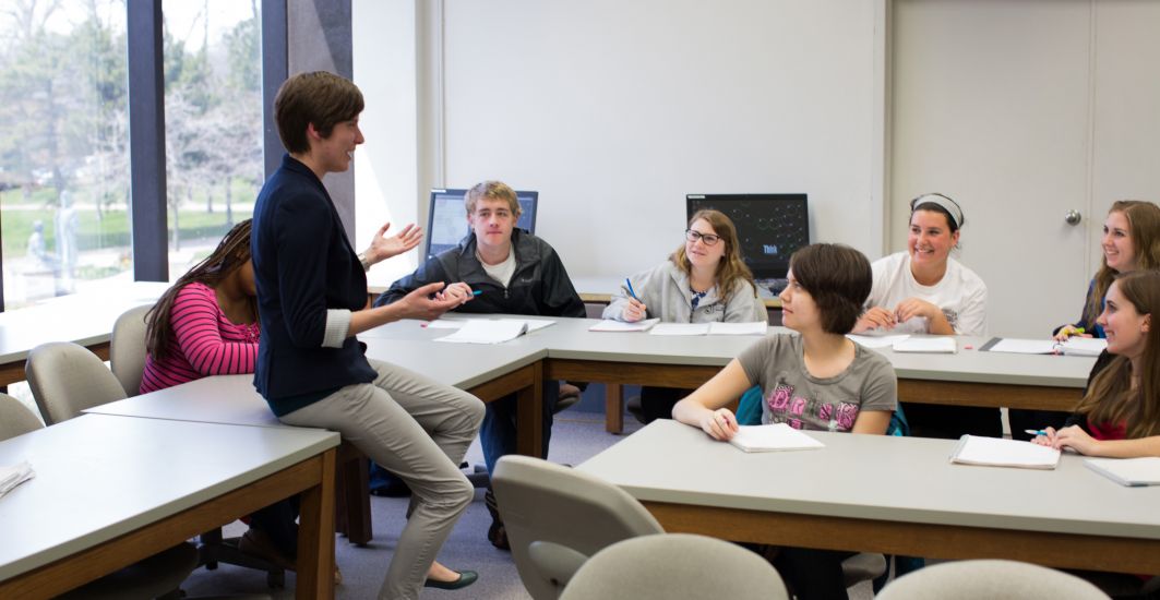 Prof. Haley Yaple helps students in a math class.
