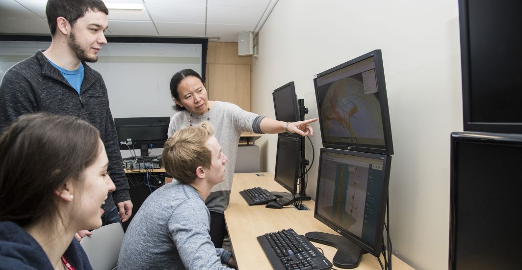 Students pursuing a geographic information science degree in a classroom.