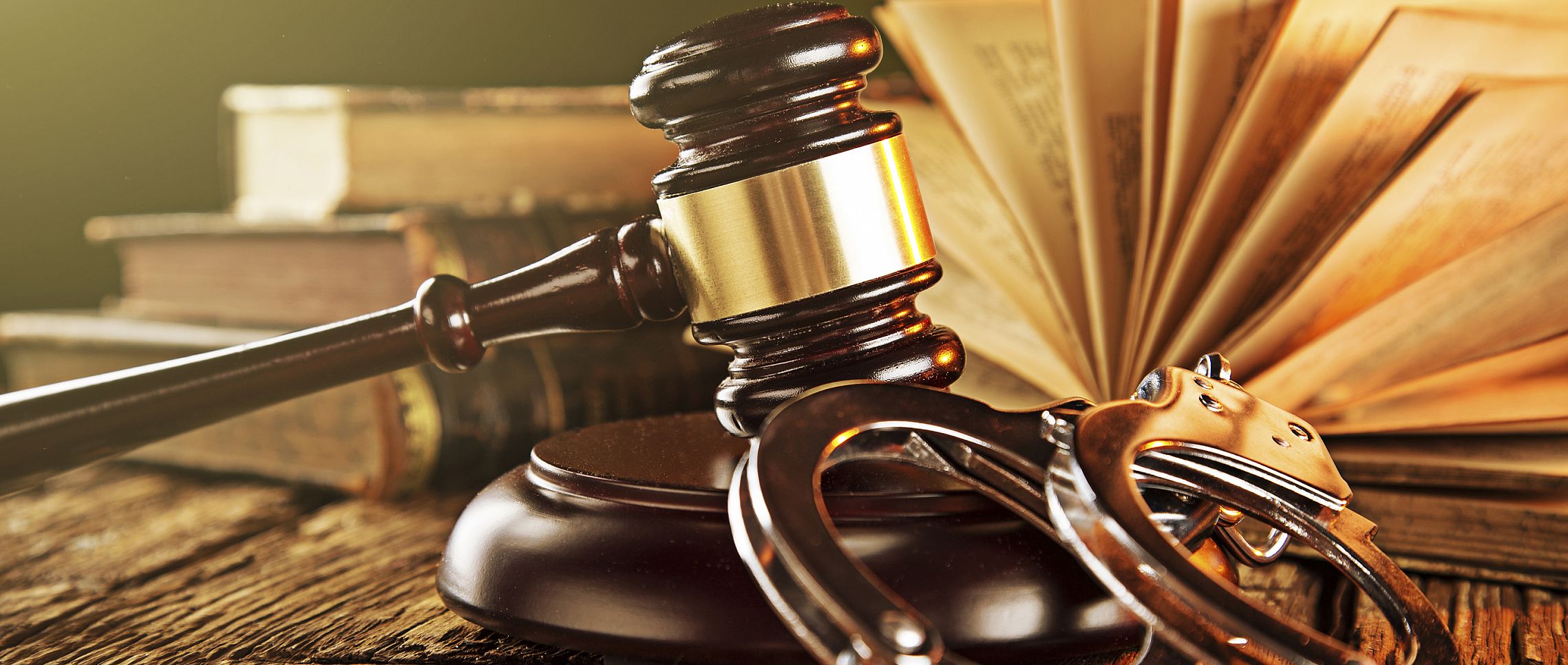 Wooden gavel and books on wooden table, law concept