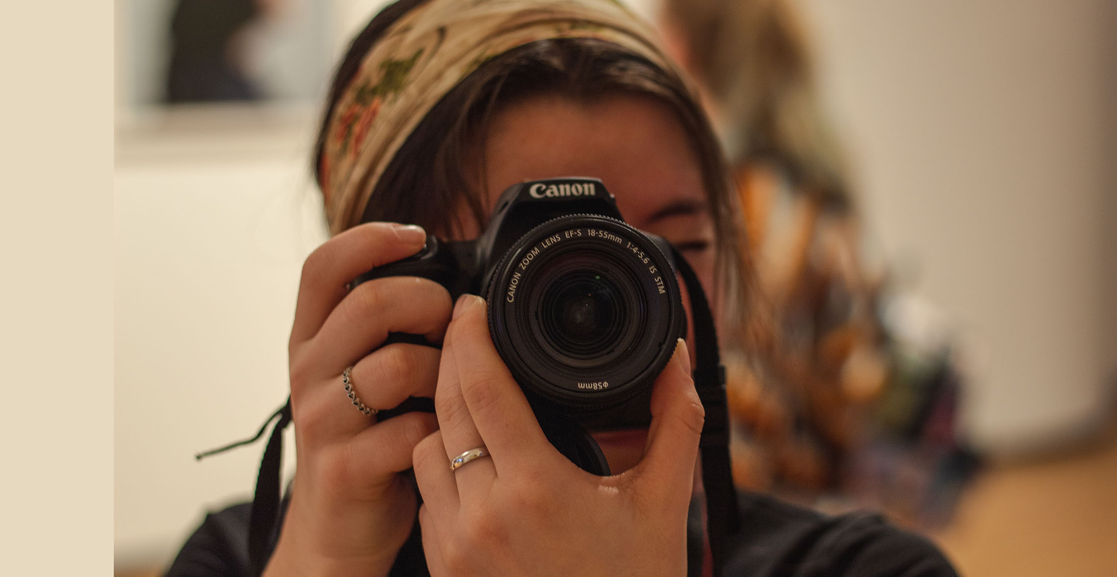 A Carthage College's photography major using a camera.