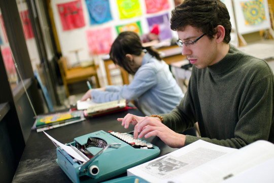 A student uses a typewriter during an on-campus J-Term course.