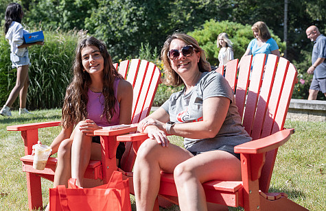 Parent and student take a break in red chairs