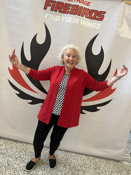 Carthage College graduate student Christy Schwan poses for a photo in front of the Firebird wings...