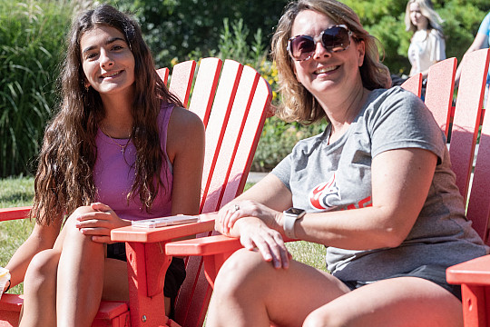 Parent and student take a break in red chairs