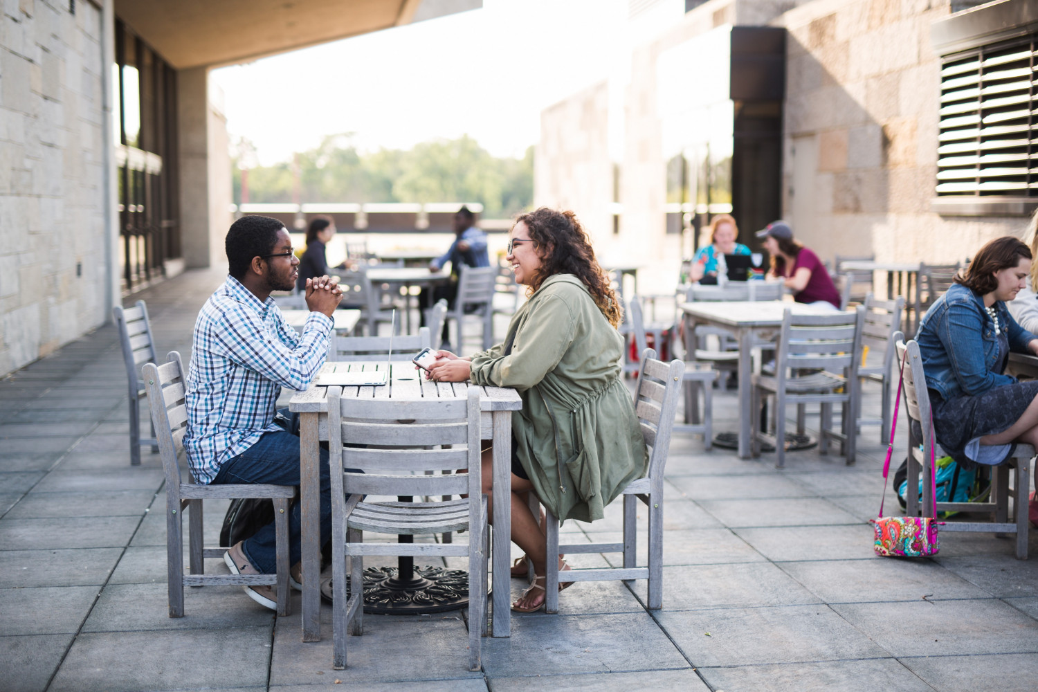 A patio with seating is located just outside the Hedberg Library.