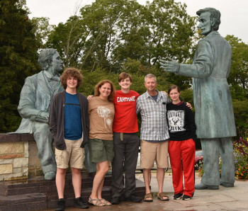 Family members pose with a new Carthage student in front of the Lincoln statue.