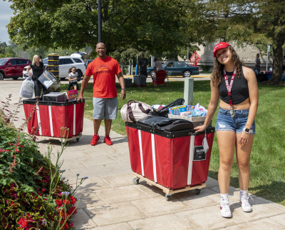 Students and families unpack their cars for move-in.
