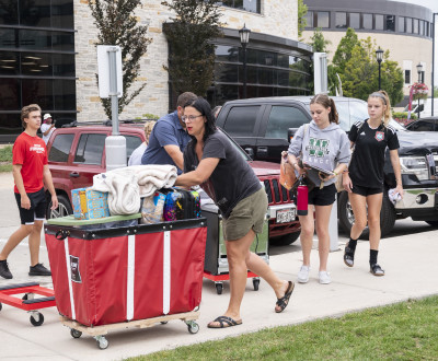 Students and families unpack their cars for move-in.